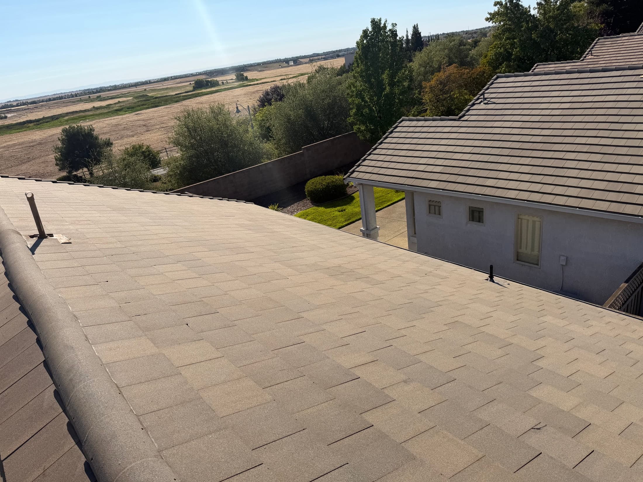 The same concrete tile roof after soft washing — uniform, clean surface from ridge to eave
